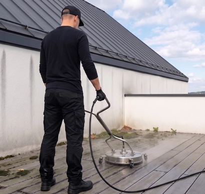 Nettoyage de terrasse en bois composite à Chambord — artisan Eauxigen en intervention softwash avec nettoyeur de surface professionnel, élimination des mousses et débris sur deck de toit-terrasse architecte, Mars 2026